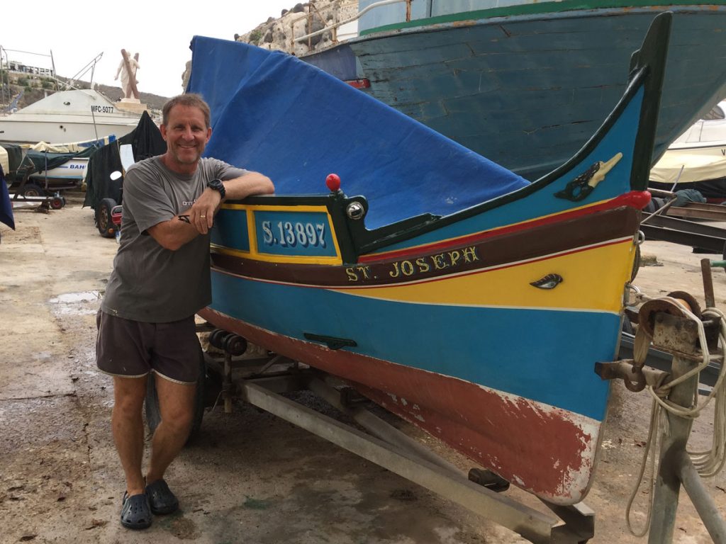 David Brient stands in front of his sailing boat. After his early business successes, David took some time to learn what he wanted to do with his life, and discovered his passion for business coaching and leadership mentoring.