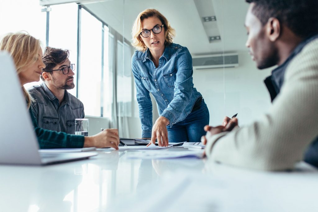 A business leader in a Norfolk boardroom talks to her team after her experiences in David Brient one-to-one executive coaching